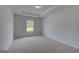 Cozy bedroom featuring neutral carpet, a tray ceiling, and a bright window at 120 Felicity Pike, Locust Grove, GA 30248