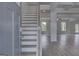Inviting entryway showcasing a staircase and open floor plan with hardwood floors and plenty of natural light at 120 Felicity Pike, Locust Grove, GA 30248