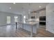 Spacious kitchen with a large center island, stylish pendant lighting, and stainless steel appliances at 120 Felicity Pike, Locust Grove, GA 30248
