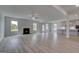 Open-concept living room features a fireplace, many windows, and seamless flow to the kitchen at 120 Felicity Pike, Locust Grove, GA 30248