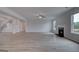 Spacious living room featuring a fireplace, ceiling fan, and neutral color palette at 120 Felicity Pike, Locust Grove, GA 30248