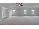 Large main bedroom showcasing multiple windows, carpet, and a ceiling fan at 120 Felicity Pike, Locust Grove, GA 30248