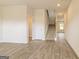 Spacious entryway with beautiful wood-look flooring and staircase leading to the upper level at 220 Fern Dale Dr # 71, Fairburn, GA 30213