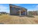 Backyard features a covered porch and low maintenance yard, perfect for outdoor entertaining at 221 Ruthe Cv, Locust Grove, GA 30248