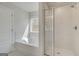 Bright bathroom features a garden tub, glass enclosed shower, and a view of the outdoors at 221 Ruthe Cv, Locust Grove, GA 30248