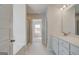 Bright bathroom with a double vanity, a bathtub and a separate glass enclosed shower at 221 Ruthe Cv, Locust Grove, GA 30248