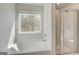 Bright white bathroom with a garden tub, glass enclosed shower and a large window at 221 Ruthe Cv, Locust Grove, GA 30248