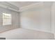 Bedroom with neutral paint, plush carpeting, and natural light from a window at 221 Ruthe Cv, Locust Grove, GA 30248