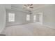 Spacious bedroom features plush carpeting, neutral walls, tray ceiling, and plenty of windows for natural light at 221 Ruthe Cv, Locust Grove, GA 30248