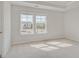Bright bedroom featuring plush carpeting, neutral paint, and plenty of natural light from the windows at 221 Ruthe Cv, Locust Grove, GA 30248