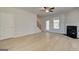 Bright living room with a fireplace, ceiling fan, neutral walls, and wood-look flooring at 221 Ruthe Cv, Locust Grove, GA 30248