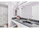Modern bathroom with a black countertop, vessel sink, and elegant lighting fixtures at 2694 Greentree Se Dr, Marietta, GA 30067