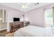 This bedroom has neutral walls, ceiling fan, hardwood floors, and a light colored bedspread at 2694 Greentree Se Dr, Marietta, GA 30067