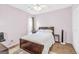 Cozy bedroom with wood frame bed, matching nightstand, sleek fan, and hardwood floors at 2694 Greentree Se Dr, Marietta, GA 30067