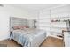Cozy bedroom with ample built-in shelving, neutral tones, and comfortable furnishings at 2694 Greentree Se Dr, Marietta, GA 30067