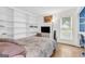 Cozy bedroom with ample built-in shelving, neutral tones, and comfortable furnishings at 2694 Greentree Se Dr, Marietta, GA 30067
