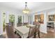 Inviting dining room features a stylish chandelier and French doors opening to an outdoor patio at 2694 Greentree Se Dr, Marietta, GA 30067