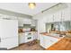 Bright kitchen showcasing white appliances, butcher block countertops, and a view into the dining area at 2694 Greentree Se Dr, Marietta, GA 30067