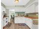 Well-lit kitchen featuring white cabinets, butcher block countertops, and modern appliances at 2694 Greentree Se Dr, Marietta, GA 30067