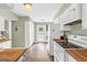 Bright kitchen with white appliances, wood countertops and flooring, and access to the backyard at 2694 Greentree Se Dr, Marietta, GA 30067