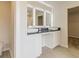 This bathroom features double sinks with stone countertops and white cabinetry at 506 Alford Cv # 89, Fairburn, GA 30213