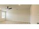 This spacious bedroom has neutral paint, a ceiling fan and a window for natural light at 506 Alford Cv # 89, Fairburn, GA 30213