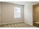 This bedroom features neutral paint and carpet and a window for natural light at 506 Alford Cv # 89, Fairburn, GA 30213