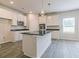 Modern kitchen showcasing a center island with dark countertops and stainless steel appliances, flooded with natural light at 506 Alford Cv # 89, Fairburn, GA 30213