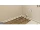 Dedicated laundry area with wood-look flooring, designed for convenience and functionality, featuring modern hookups and neutral decor at 506 Alford Cv # 89, Fairburn, GA 30213