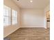 This large living room features wood-look floors, neutral paint and tons of natural light at 506 Alford Cv # 89, Fairburn, GA 30213