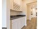 Pantry features a wine rack, granite countertop, and ample cabinet space, offering elegant storage and functionality at 506 Alford Cv # 89, Fairburn, GA 30213