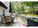 A wooden deck with a table, chairs, and grill, great for outdoor dining and entertaining at 1612 Cagle Ct, Lawrenceville, GA 30045
