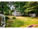 Spacious backyard featuring multiple storage buildings, perfect for hobbies or extra storage at 1612 Cagle Ct, Lawrenceville, GA 30045