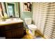 Bathroom featuring a toilet, shower curtain, a vanity, and a mirror at 1612 Cagle Ct, Lawrenceville, GA 30045