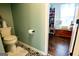 Cozy bathroom with decorative floor tiling, a toilet, and a view to the next room at 1612 Cagle Ct, Lawrenceville, GA 30045
