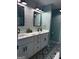 Modern bathroom with double vanity, decorative tile floors, shiplap accent wall, and sleek black fixtures at 1612 Cagle Ct, Lawrenceville, GA 30045