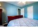 Bedroom featuring blue walls, a ceiling fan, a closet, and dark hardwood floors at 1612 Cagle Ct, Lawrenceville, GA 30045