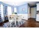 Bright dining area with hardwood floors, updated light fixture, and large bay window at 1612 Cagle Ct, Lawrenceville, GA 30045