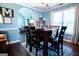 Open dining room with a hardwood table, area rug, and an archway to the living room at 1612 Cagle Ct, Lawrenceville, GA 30045
