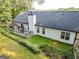 An aerial view shows a house with a dark roof, a chimney, a deck with furniture and surrounding vegetation at 1612 Cagle Ct, Lawrenceville, GA 30045