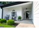 Inviting front porch with rocking chairs, a welcome sign, and a beautifully landscaped yard at 1612 Cagle Ct, Lawrenceville, GA 30045