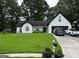 Charming white home with a manicured front yard, a covered entryway, and an attached two-car garage at 1612 Cagle Ct, Lawrenceville, GA 30045