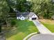 Charming home with well-manicured lawn, long driveway, and attached garage at 1612 Cagle Ct, Lawrenceville, GA 30045