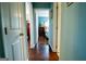Long hallway featuring hardwood floors with access to bedrooms and common areas at 1612 Cagle Ct, Lawrenceville, GA 30045