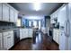 Bright eat-in kitchen featuring stainless steel appliances, granite countertops, and hardwood floors at 1612 Cagle Ct, Lawrenceville, GA 30045