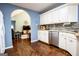 Open kitchen featuring stainless steel appliances, granite countertops, and hardwood floors at 1612 Cagle Ct, Lawrenceville, GA 30045