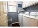 Spacious laundry room with cabinets, washer, dryer, window and stylish decor at 1612 Cagle Ct, Lawrenceville, GA 30045