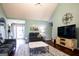 Comfortable living room with vaulted ceilings, stylish furniture, and a large TV at 1612 Cagle Ct, Lawrenceville, GA 30045