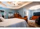 Large main bedroom featuring hardwood floors, a ceiling fan, and ample closet space at 1612 Cagle Ct, Lawrenceville, GA 30045