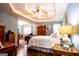 Spacious main bedroom featuring hardwood floors, a tray ceiling, and abundant natural light at 1612 Cagle Ct, Lawrenceville, GA 30045